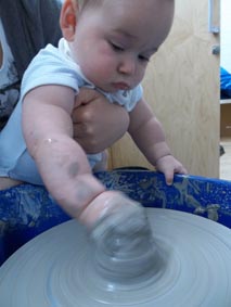 clay baby on a potter's wheel, workshop led by Jon Williams, the Flying Potter from Eastnor Pottery