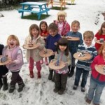 Ellen and her friends proudly show off their wonderful pottery animals in the snow covered garden at eastnor pottery herefordshire