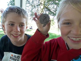 a couple of children enjoy working with clay at mudrunner oblivion event in eastnor deer park