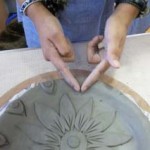 a finely decorated clay plate made by a new parent at washwood heath nursery school in birmingham