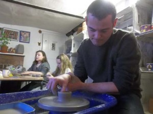family learn how to make pottery on the potter's wheel at eastnor pottery herefordshire