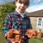 child collecting her pottery she made at eastnor pottery and the flying potter