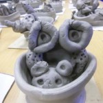 Clay alien in a pot made by child at holiday club in Walsall school