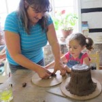 mother and child make a clay pottery gift for child minder as a moving on to school goodbye present