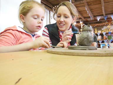 creative activity at Christmas time family making clay models at Eastnor Pottery