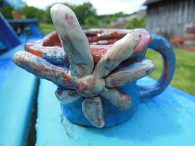 A slip painted coil pot made by school children at Burghill Primary School in Herefordshire