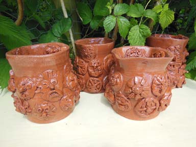 Collaborative terracotta wheel thrown pots made at Kings Hawford School Worcester