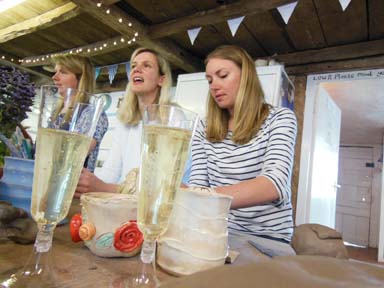 Girls enjoying a glass of prosecco as they make pottery at a hen party in Herefordshireo