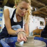 Careful hands on the potter's wheel