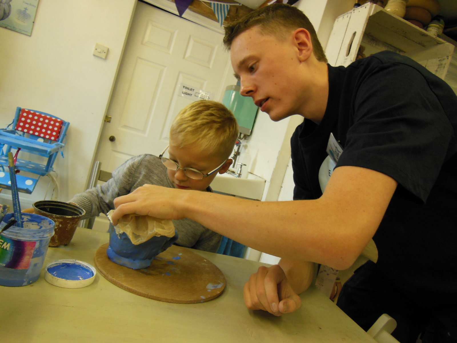 digital apprentice Jack gets hands on with clay with a young pottery customer