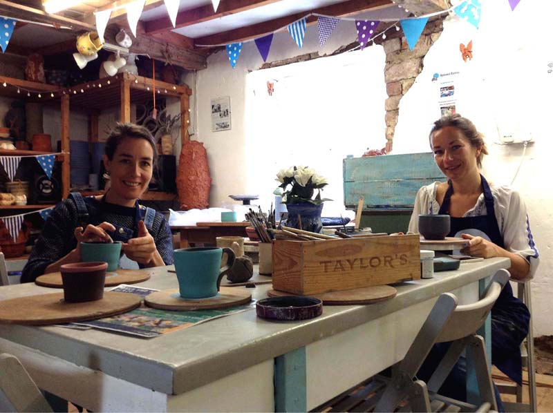 Pottery students painting brilliant pots