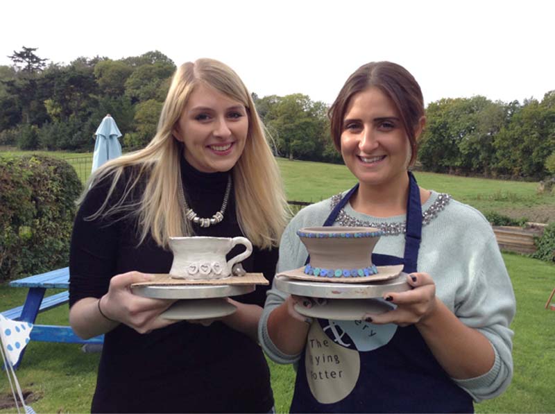 Two happy girls with brilliant pottery pieces at Eastnor