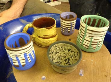 painted clay pots made on the potter's wheel by a beginner