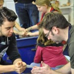 Eastnor Pottery's Apprentice Ethan teaching customer how to throw on the Potter's Wheel
