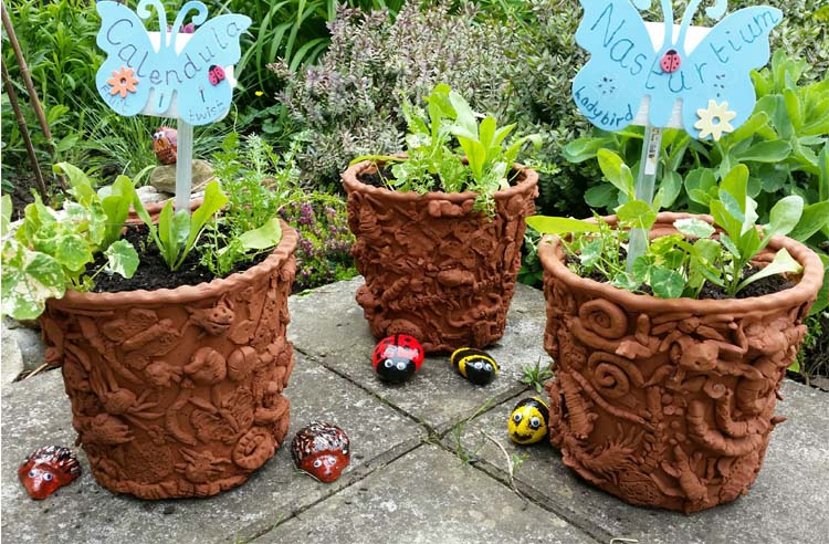 Eastnor Pottery and Bishops Cleeve work together to make terracotta coil pot planters