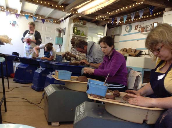 Potter's Wheel Workshop Participants at Eastnor Pottery perfecting their thrown creations 
