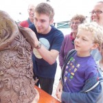 Jacob the Potter helping at Eastnor Castle making ceramic dinosaur heads