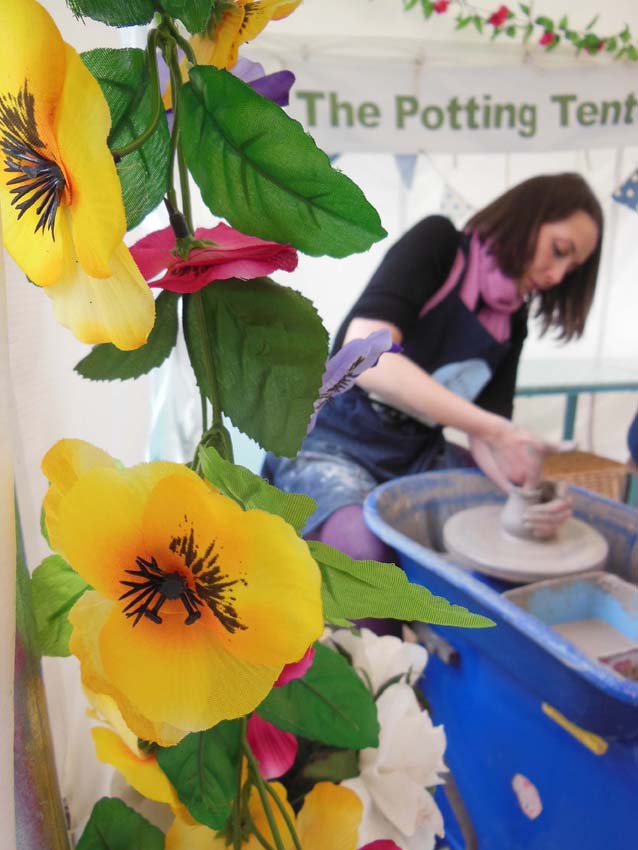 Hen making a pot on the potter's wheel at eastnor pottery and the flying potter