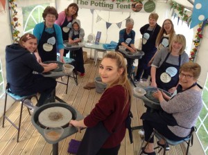 70th birthday party celebration at eastnor pottery andthe flying potter taking turns on four pottery kick wheels.