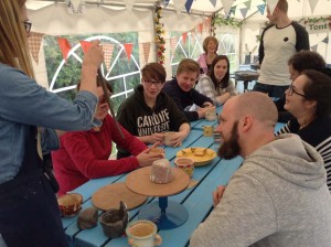 birthday party of adults watchingf a pottery demonstration by Sarah the Potter