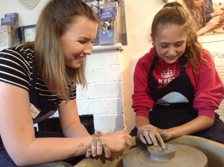 Child receiving potter's wheel tuition at Eastnor Pottery
