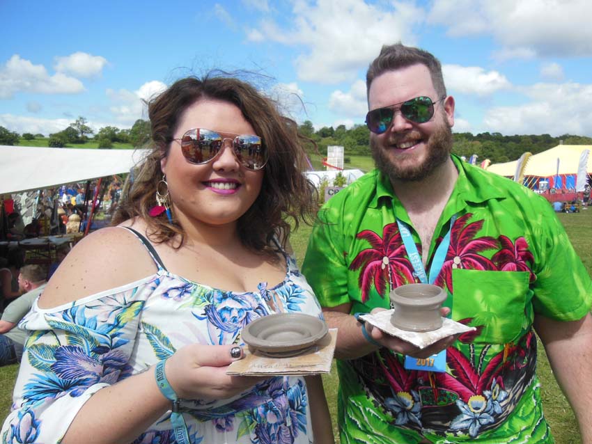 Couple display their potter's wheel pots at Lakefest Festival in Herefordshire