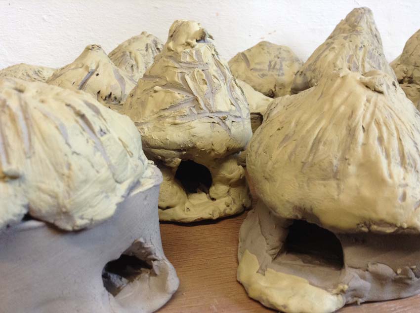 iron age round houses models made from pottery by children at Finstall First school in Bromsgrove