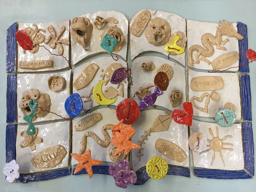 tile panel in the shape of a book made by young people from SHYYP at Ross on Wye Library